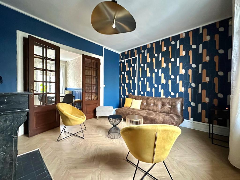 a living room with a brown couch and yellow chairs at Maison Familiale Le Havre in Le Havre