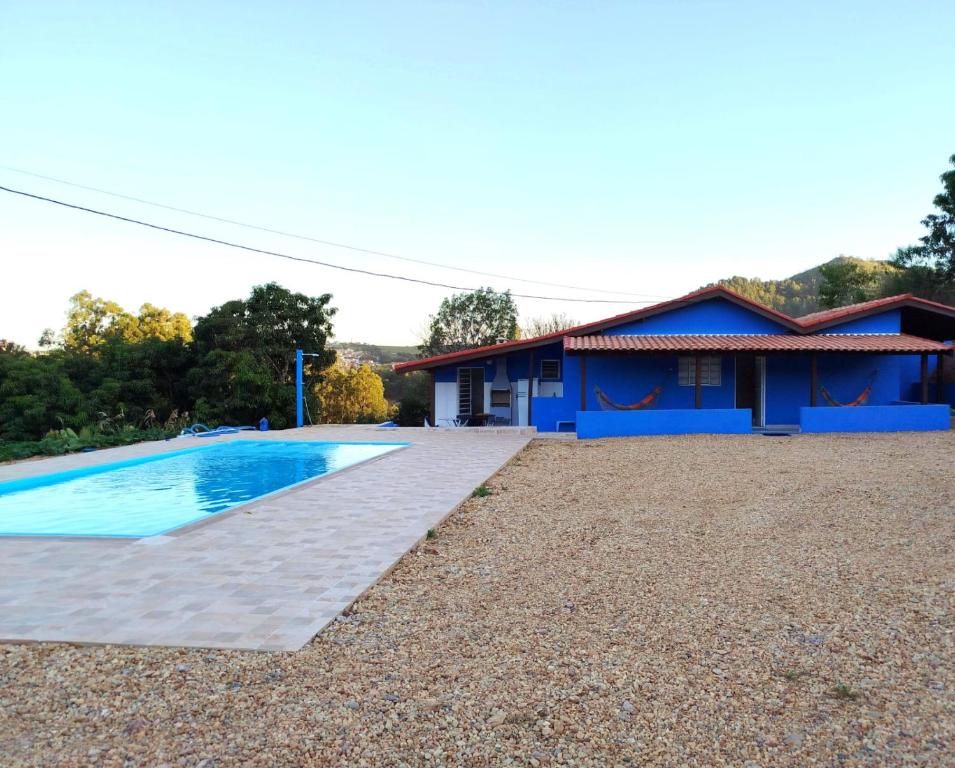 a house with a swimming pool in front of it at Casinha Virtuosa in Monte Sião