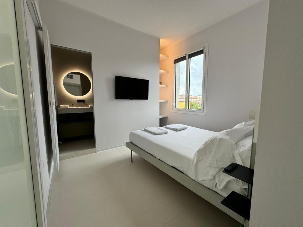 a white bedroom with a bed and a sink at Modflor Urban Flat Florence in Florence