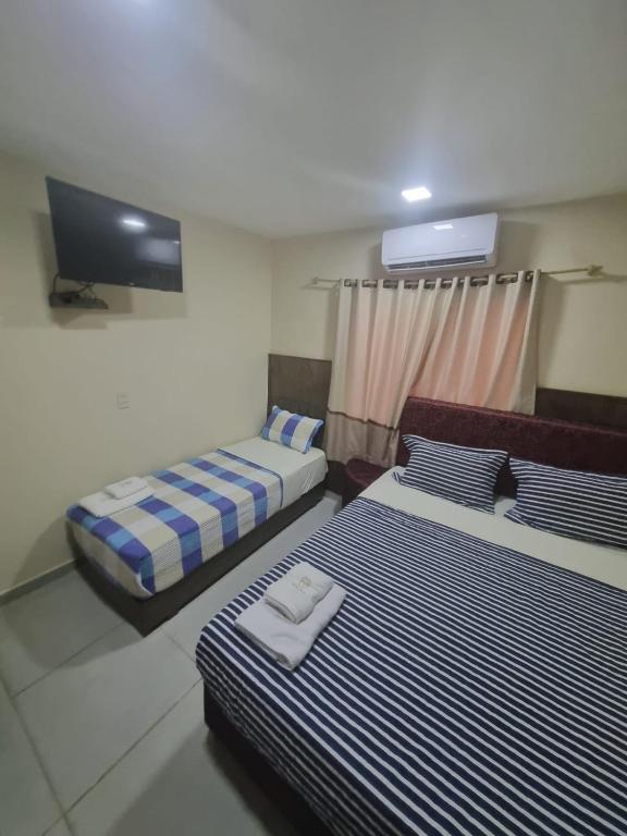 Postel nebo postele na pokoji v ubytování Hotel Villa