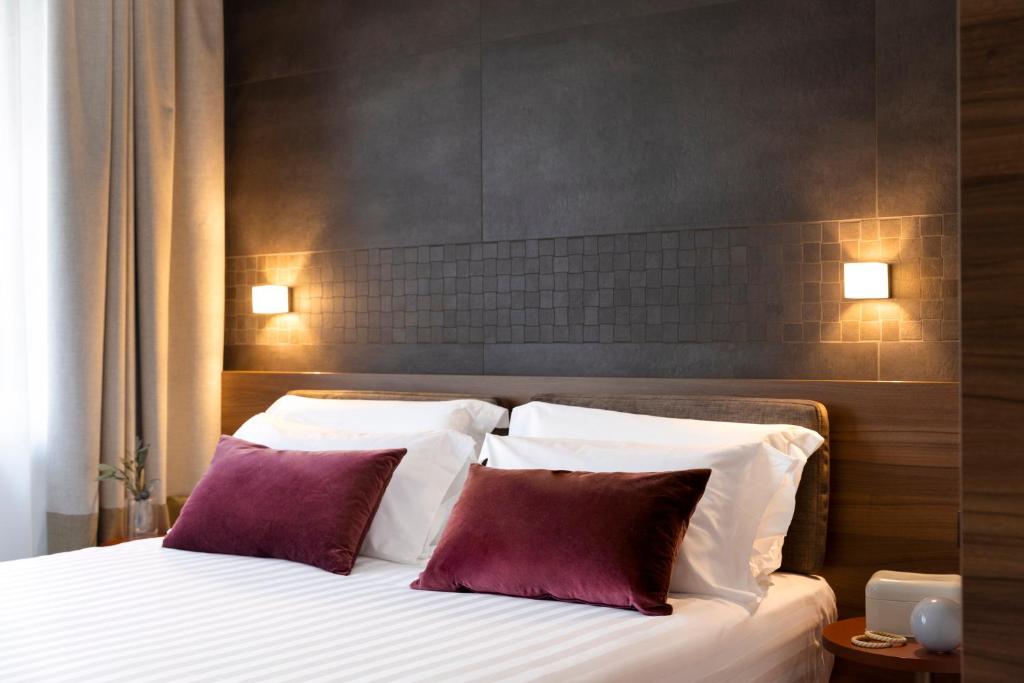 Postel nebo postele na pokoji v ubytování Adoro Hotel