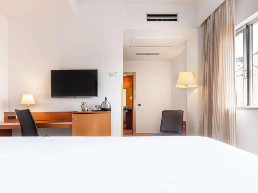 TV a/nebo společenská místnost v ubytování Hotel Zentral León