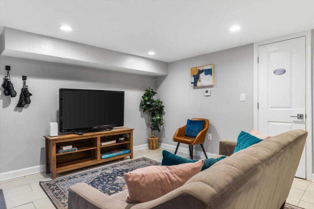 a living room with a couch and a flat screen tv at Walk to Parks Restaurants Monuments & More in Washington, D.C.