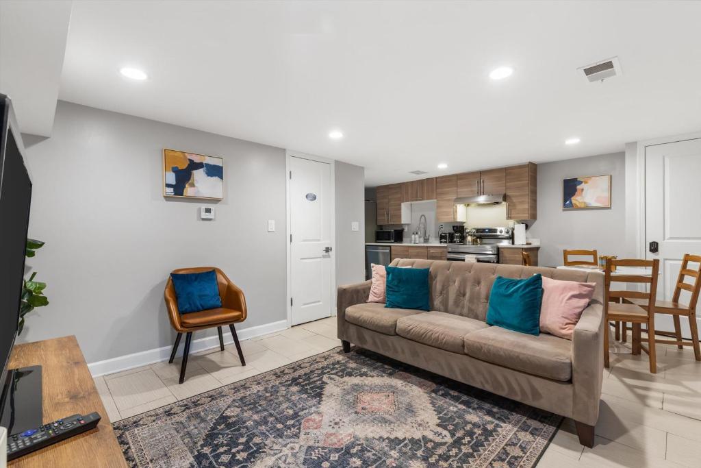 a living room with a couch and a kitchen at Walk to Parks Restaurants Monuments & More in Washington, D.C.