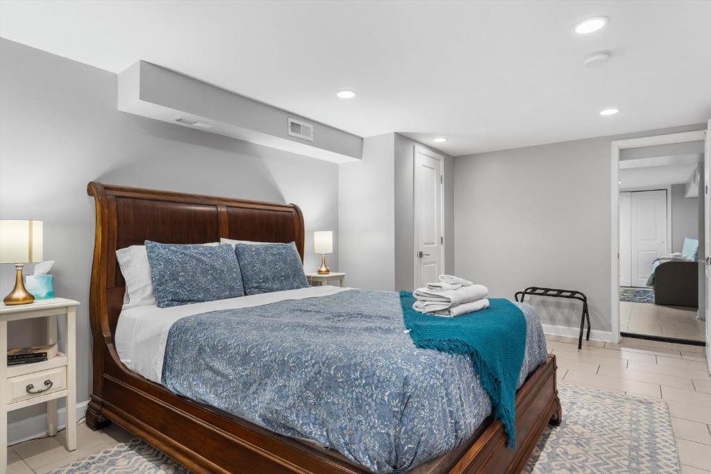 a bedroom with a bed with a blue blanket at Walk to Parks Restaurants Monuments & More in Washington, D.C.