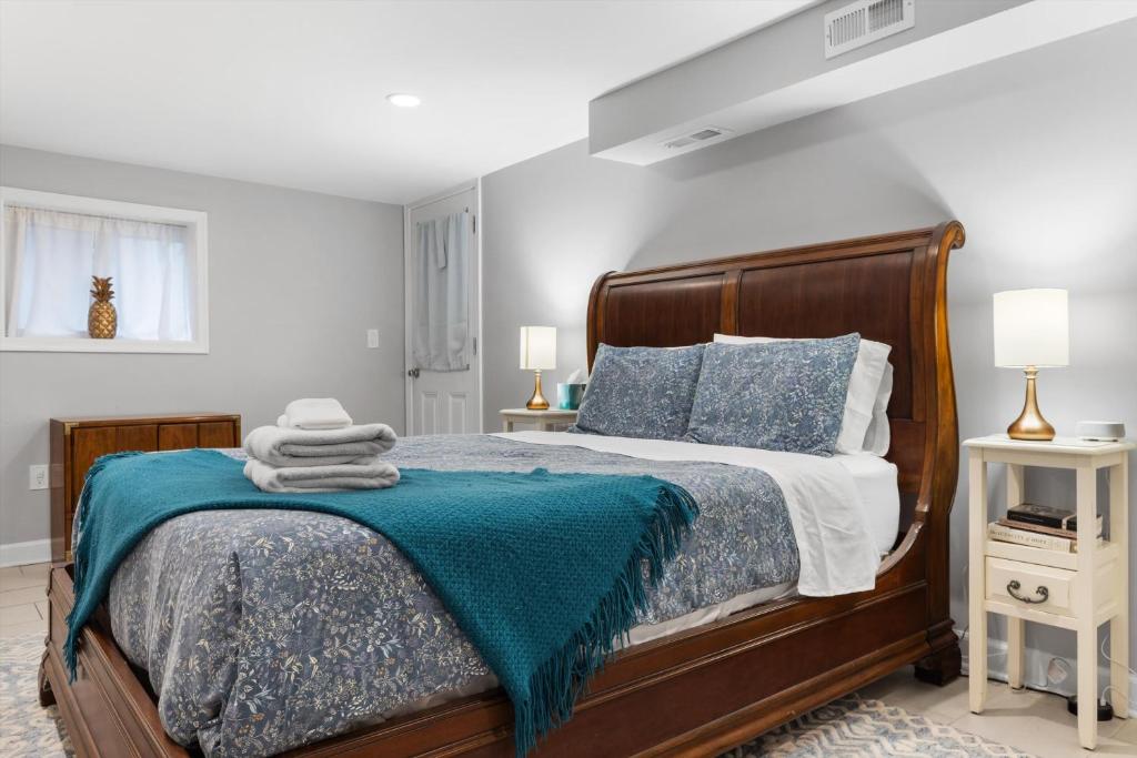 a bedroom with a bed with a blue blanket on it at Walk to Parks Restaurants Monuments & More in Washington, D.C.