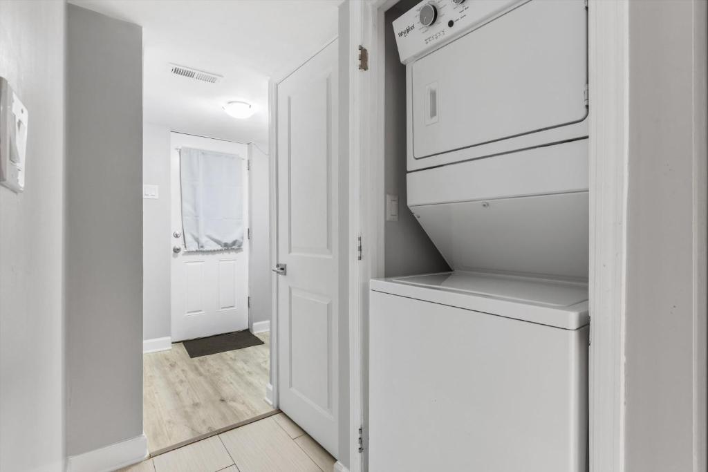 a kitchen with white cabinets and a refrigerator at Walk to Parks Restaurants Monuments & More in Washington, D.C.