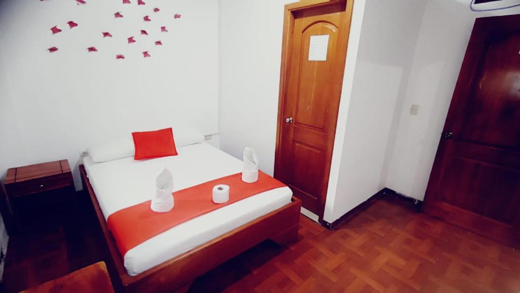 Postel nebo postele na pokoji v ubytování Hostal El Pinzón