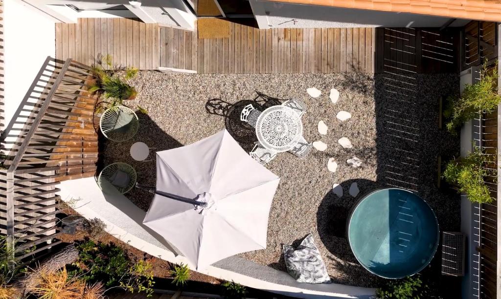 Elle offre une vue sur la terrasse dotée d'un parasol. dans l'établissement Cottage Petit Piladi, à Lacanau