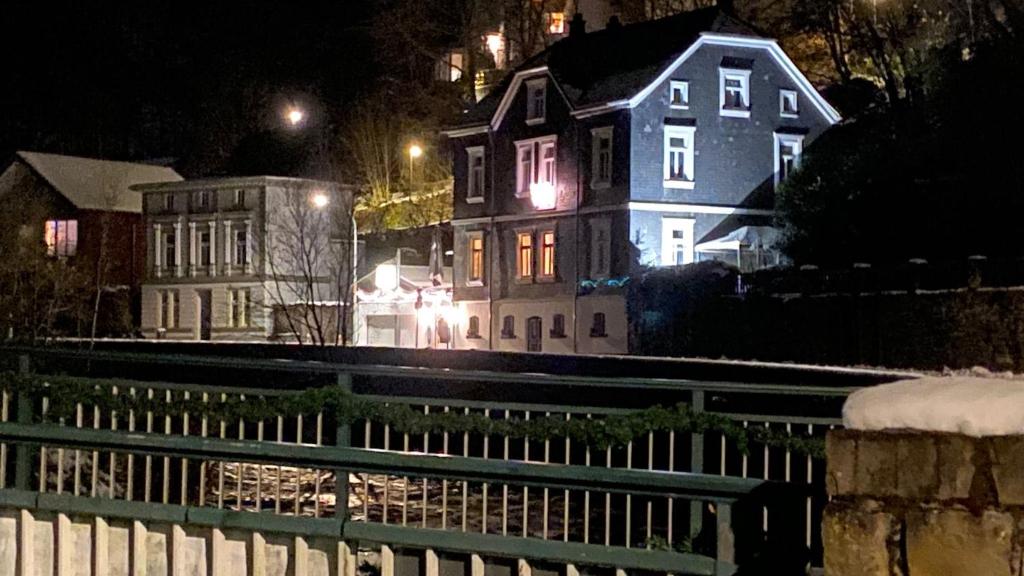 a group of houses at night with lights at Villa Burgau, C&H in Monschau