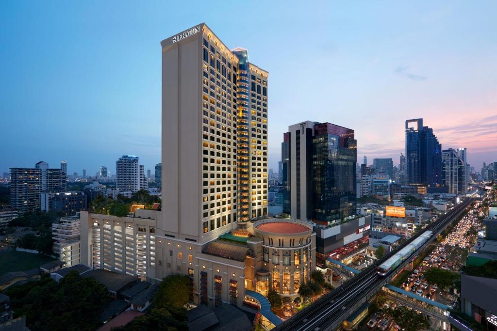 a tall building in a city at night at Sheraton Grande Sukhumvit, a Luxury Collection Hotel, Bangkok in Bangkok