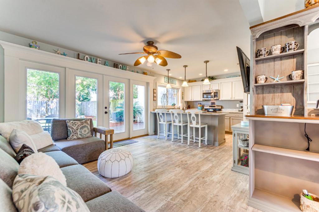 a living room with a couch and a kitchen at 2 Private Outdoor Spaces Gulf Breeze Townhome! in Gulf Breeze