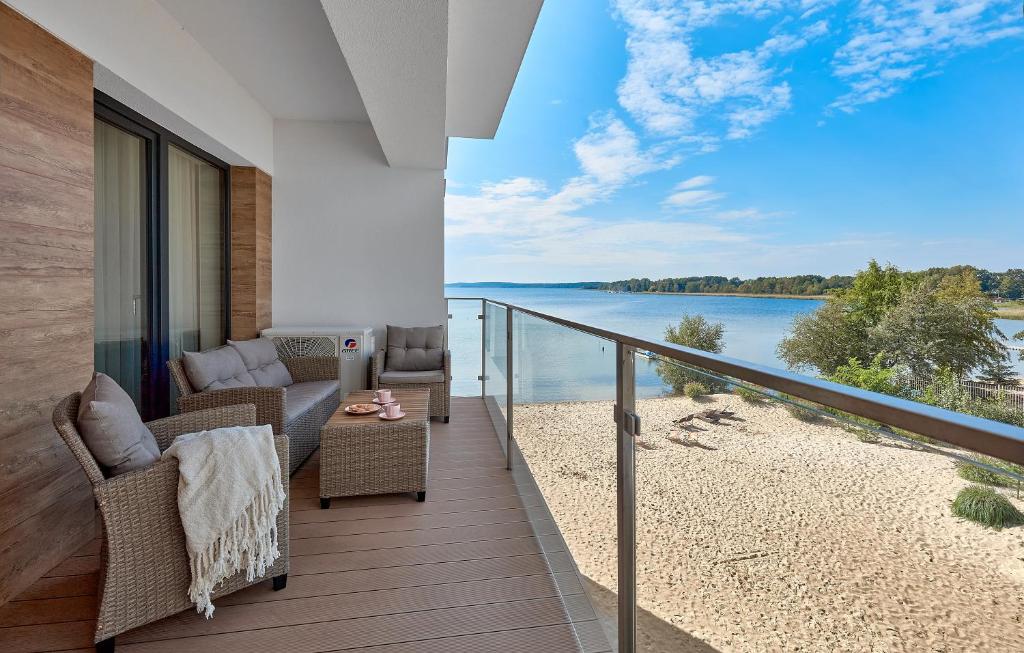 a balcony with chairs and a view of the water at Boszkowo Horizon Park Apartament 27 "Romantic" in Boszkowo