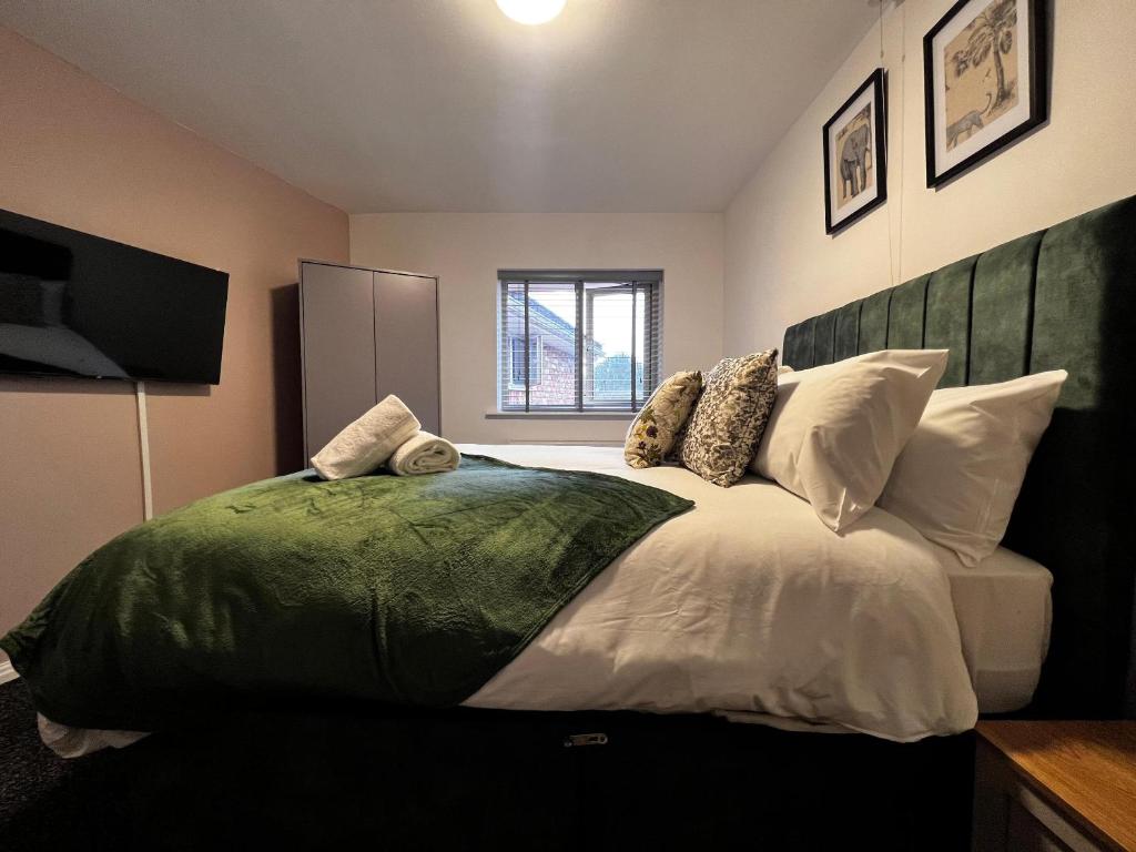 a bedroom with a large bed with pillows at BV Aparthotel Castleford Perfect for Cooperate and Leisure Stays in Castleford