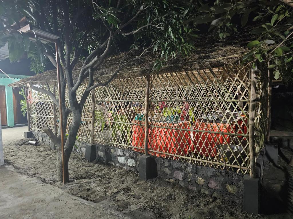 a fence with a bunch of animals in it at The Ashok Vatika Farms and Stay in Haridwār