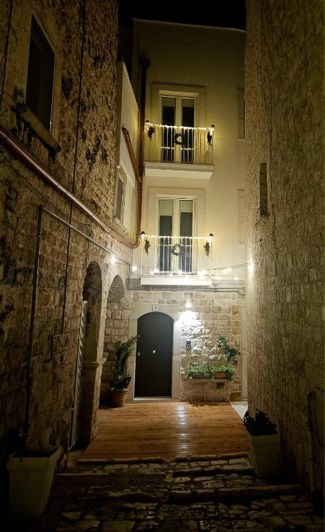 a building with a door and a balcony at night at Corte San Pietro -Apartments in Molfetta