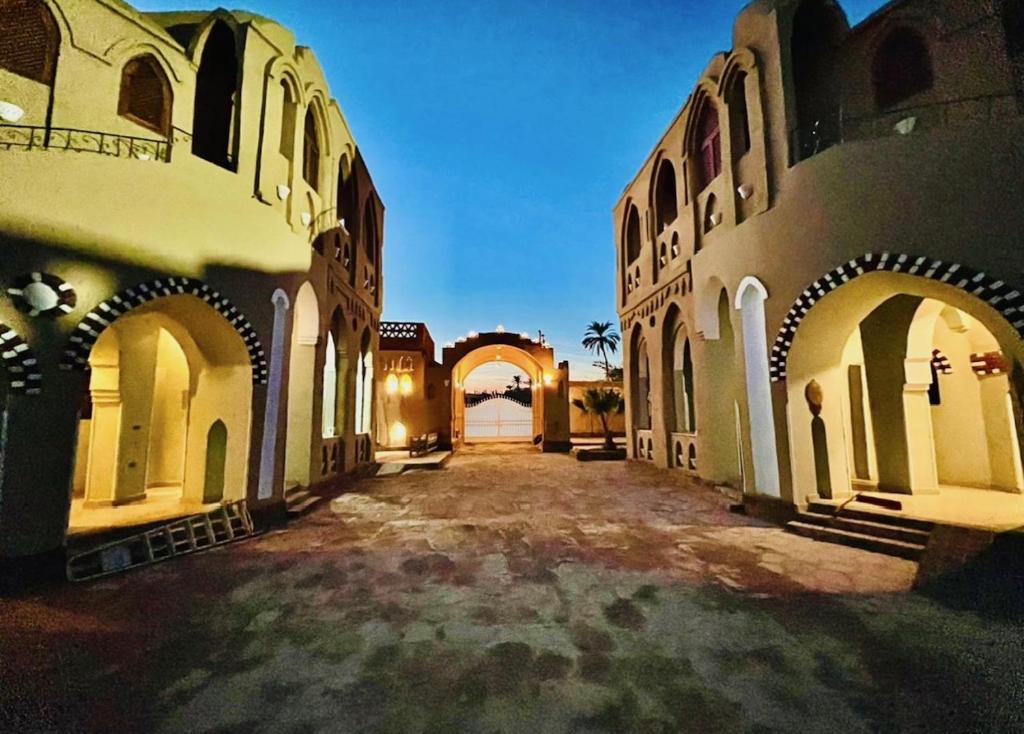 an empty courtyard of a building with arches at Leyla Eco Resort Queen Suites in Luxor