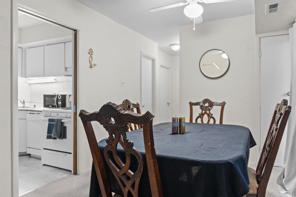 a dining room with a table and chairs and a clock at Your perfect stay - Cozy 2BR apartment in NOVA in Arlington