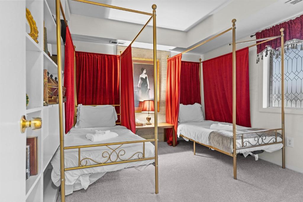 two beds in a room with red curtains at Your perfect stay - Cozy 2BR apartment in NOVA in Arlington