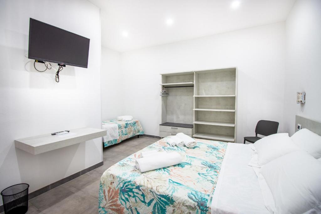 Postel nebo postele na pokoji v ubytování S'Omu e Chicchinu Rooms