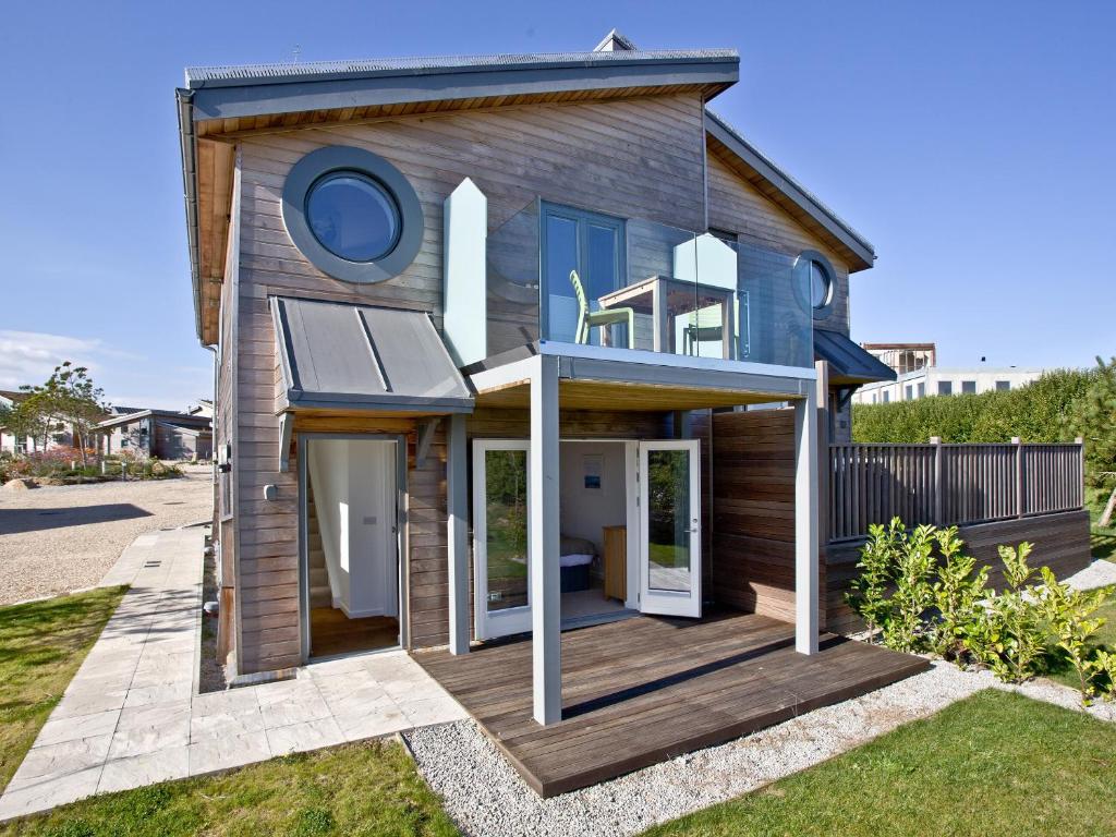una casa con terraza de madera en el patio en Una Aurum 57, en Carbis Bay