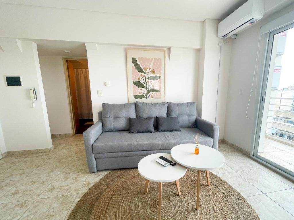 a living room with a couch and a table at Saavedra 118 8F by depptö in Bahía Blanca