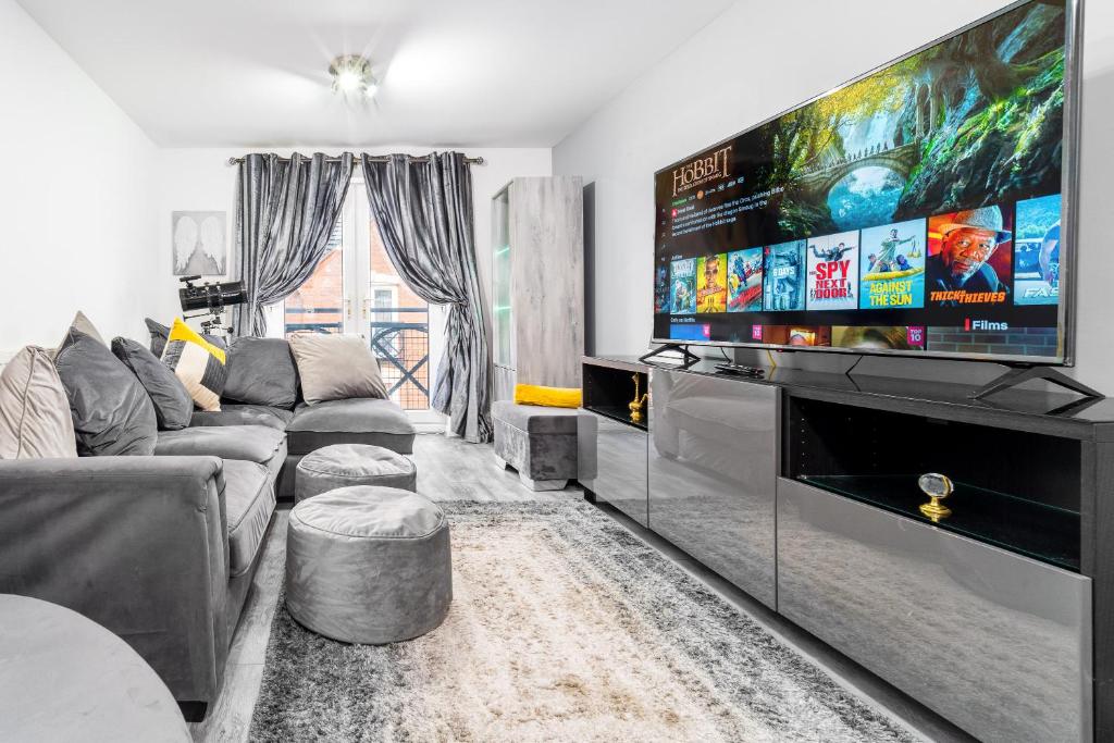 a living room with a large flat screen tv at Middle Meadow 2 bedroom Modern Apartment Sleeps 3 Contractors Families in Tipton