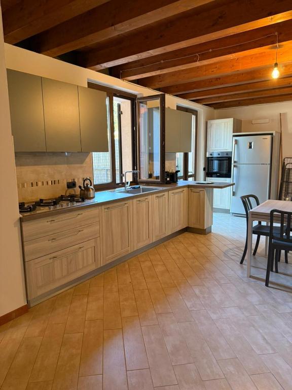 a kitchen with wooden cabinets and a table and chairs at Terrazza House in Palazzolo
