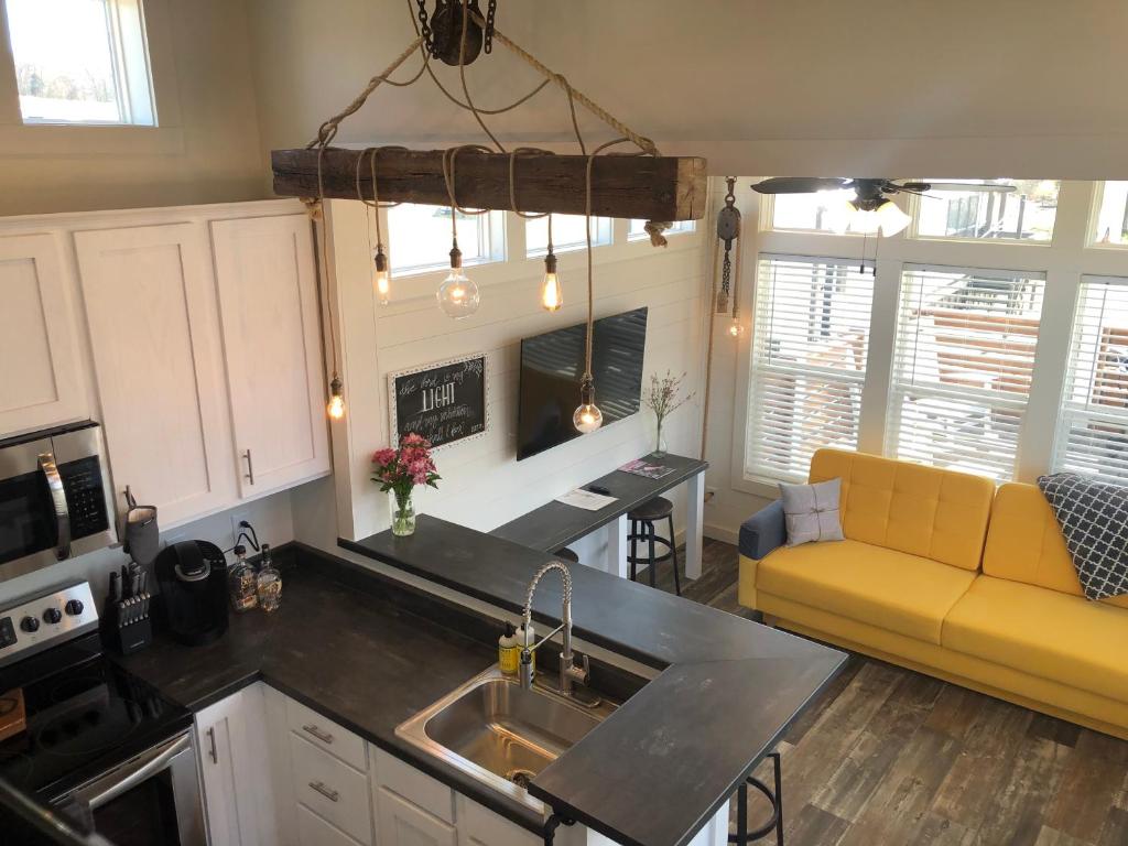a kitchen and living room with a yellow couch at Piney River Resort in Bon Aqua