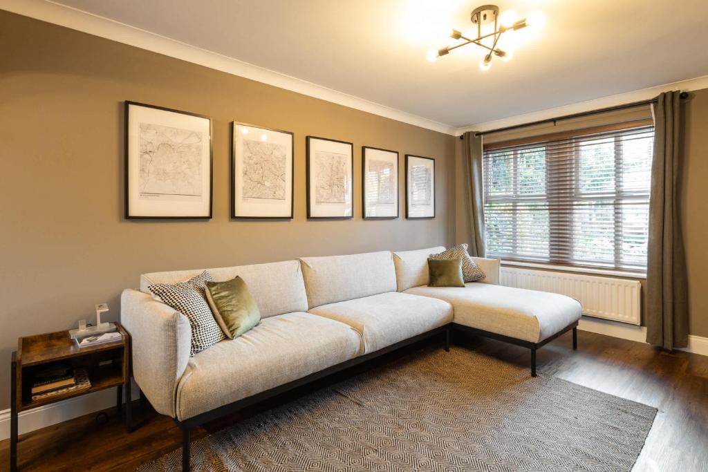 a living room with a white couch and a chair at Host & Stay - Martinhoe in Yarm