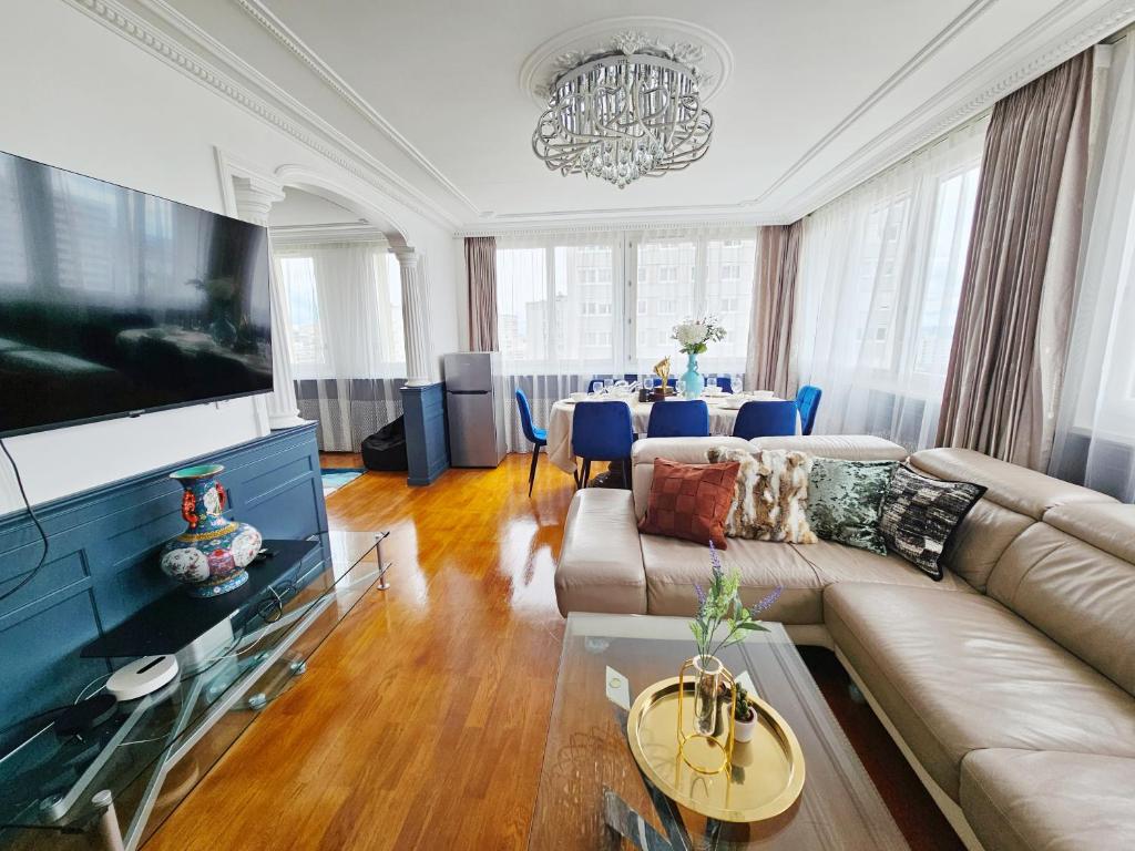 un salon avec un canapé et une télévision dans l'établissement Apt vue panoramique parking free, à Paris