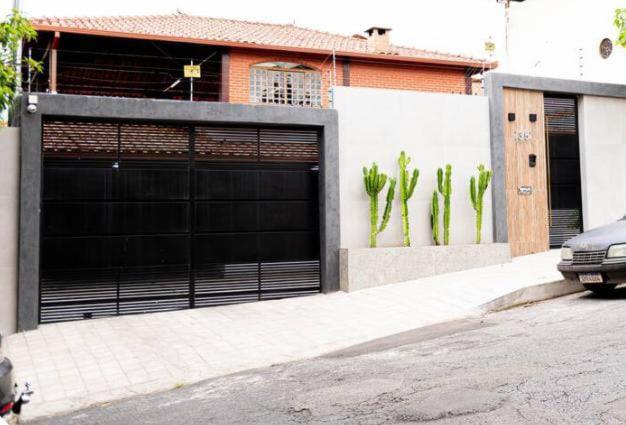 een gebouw met twee garagedeuren in een straat bij Casa Enorme com Piscina, Sauna e Área para Festas in Belo Horizonte