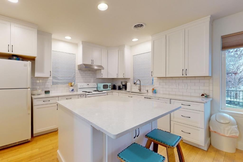 a kitchen with white cabinets and a white counter top at Manson Hideaway in Manson