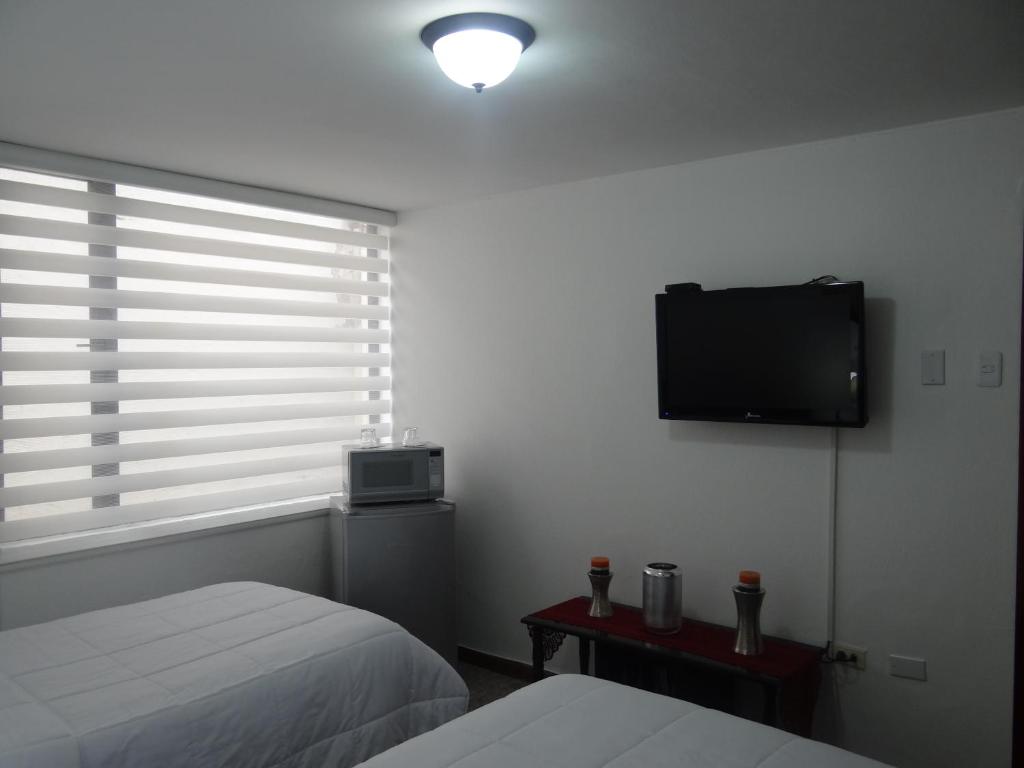 TV a/nebo společenská místnost v ubytování Altura Rooms & Suites