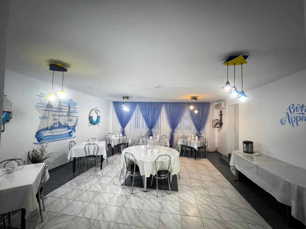 a restaurant with tables and chairs in a room at Кемпинг Мечта in Uralsk