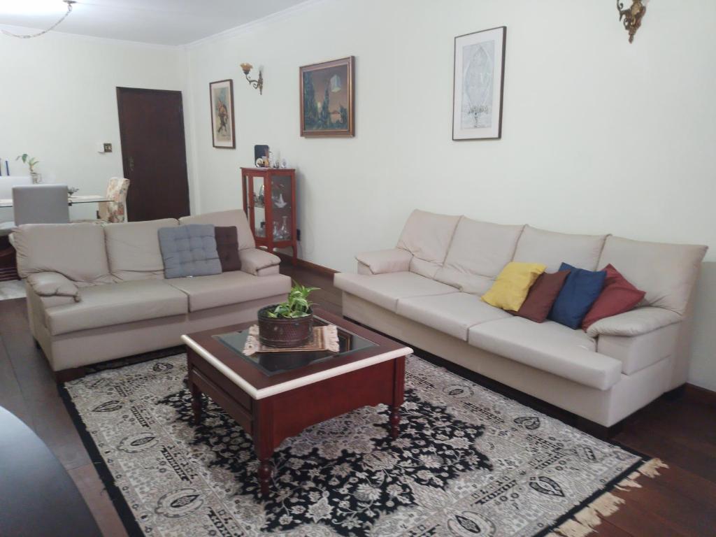 a living room with a couch and a coffee table at Apartamento Gonzaga Santos in Santos