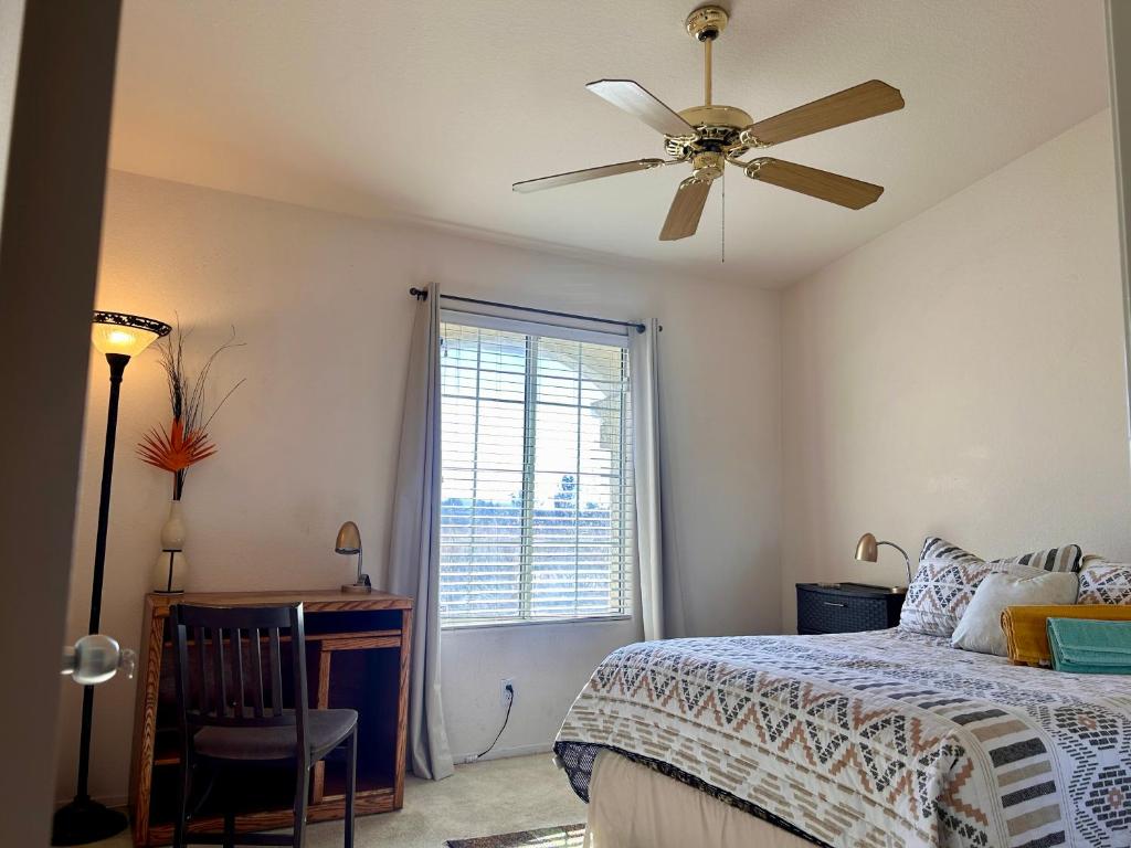 a bedroom with a bed and a ceiling fan at Western Horizon Home in Hemet