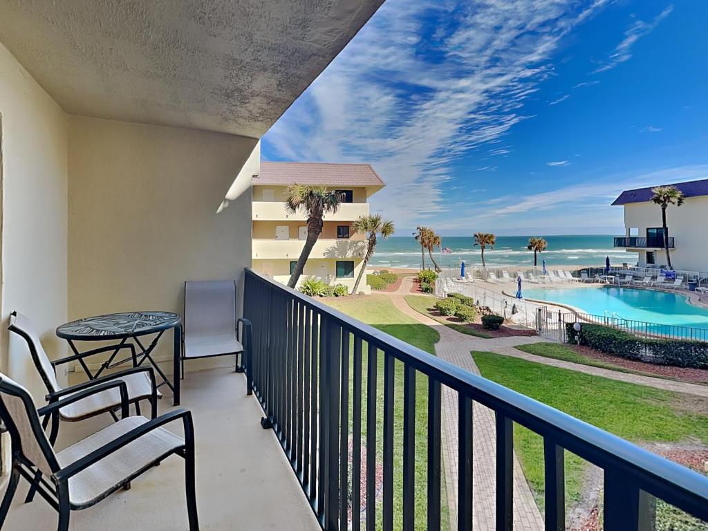 a balcony with a view of the beach and the ocean at Bent Palm 218 in Ormond Beach