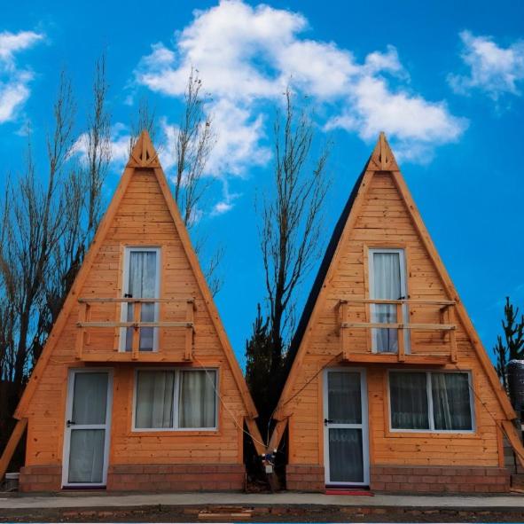 a house with two pointed roofs on top of it at Cabaña la turka in Perito Moreno