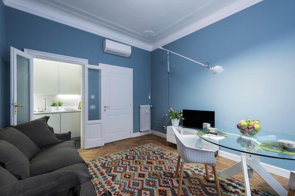 a blue living room with a couch and a table at Zebra Rosso in Milan