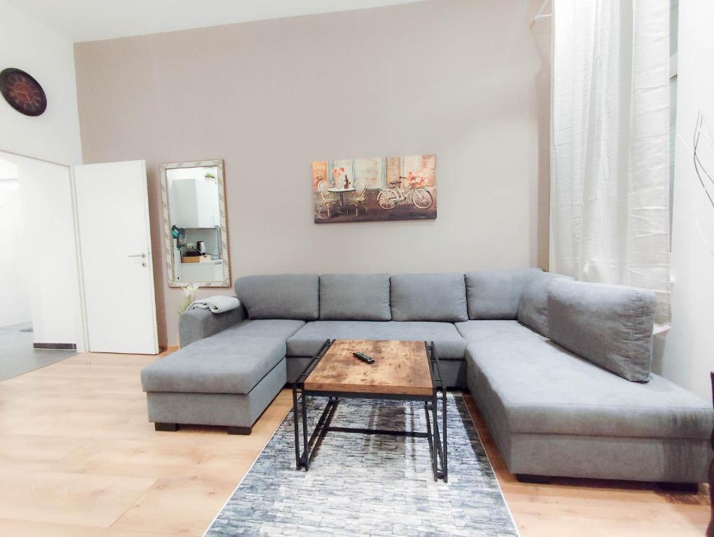 a living room with a couch and a coffee table at Cozy Apartments in Central Location with Free Parking on Availability in Vienna