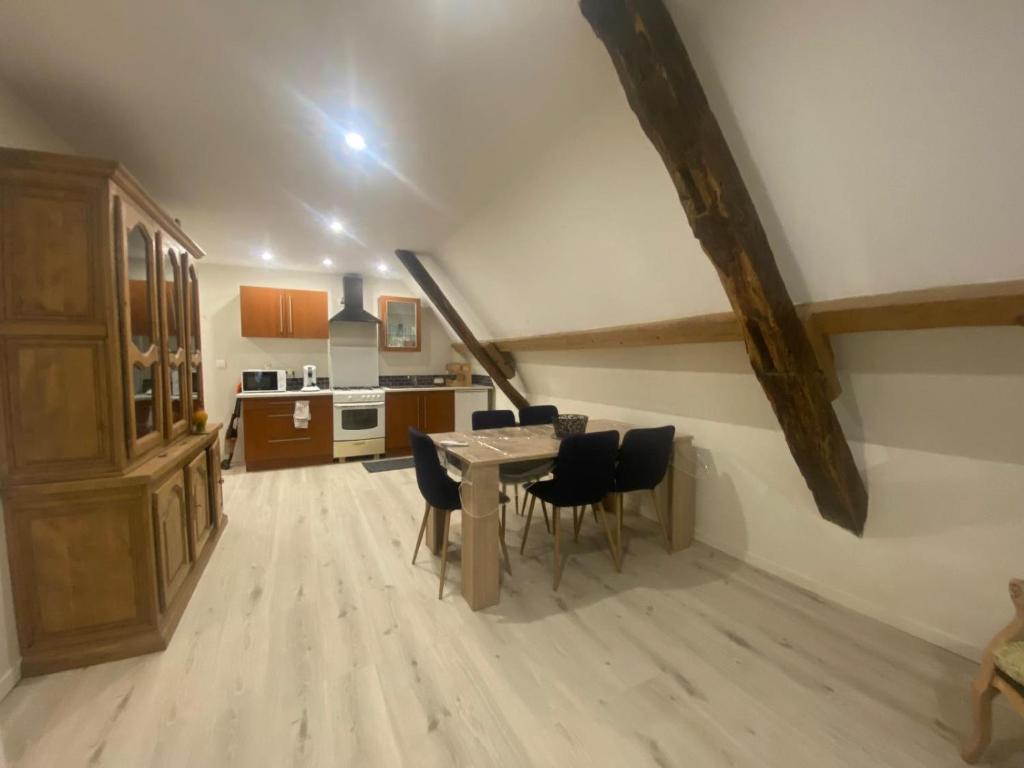 a kitchen and dining room with a table and chairs at Le petit refuge in Saint-Béron
