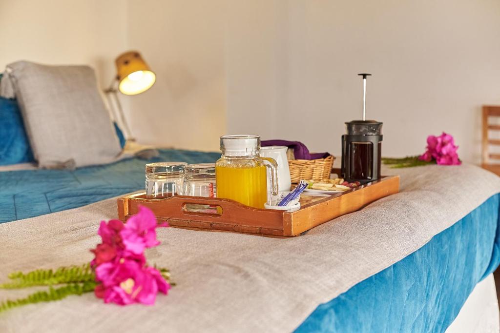 a tray of honey and flowers on a bed at Takarua Lodge in Hanga Roa