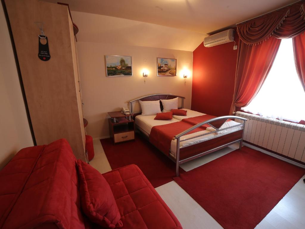 Postel nebo postele na pokoji v ubytování Hotel Ženeva