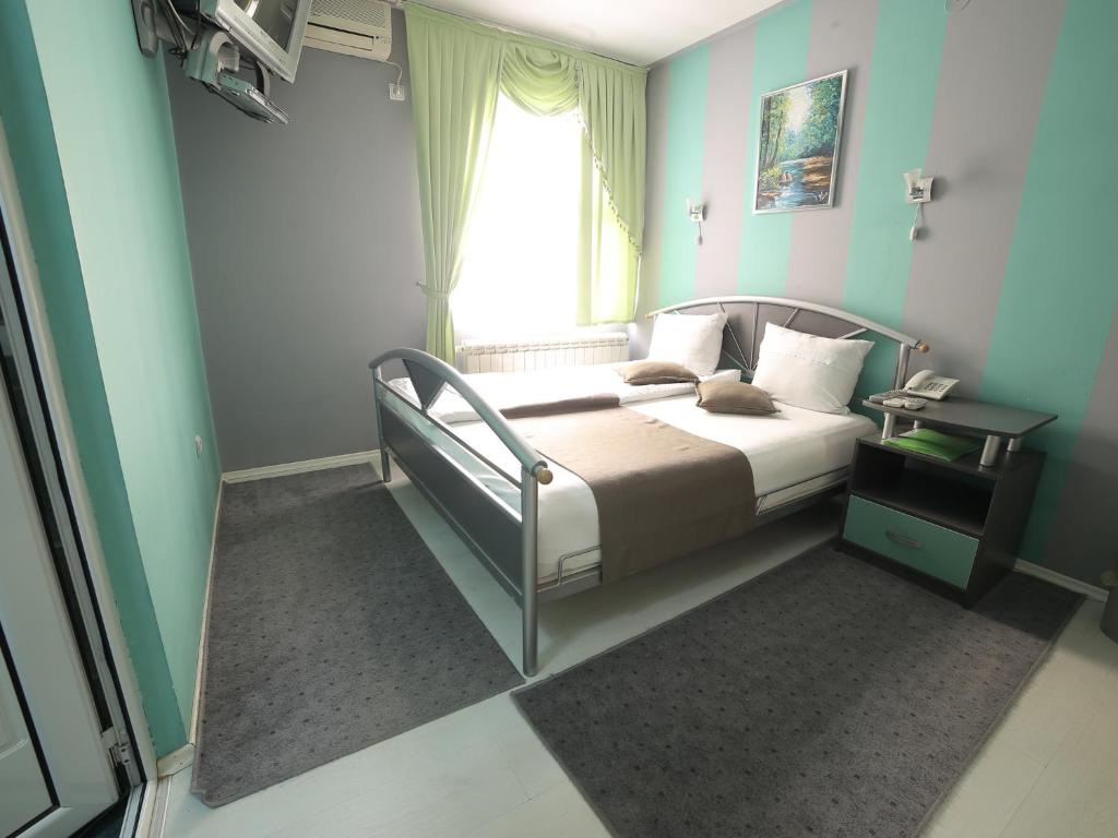 Postel nebo postele na pokoji v ubytování Hotel Ženeva