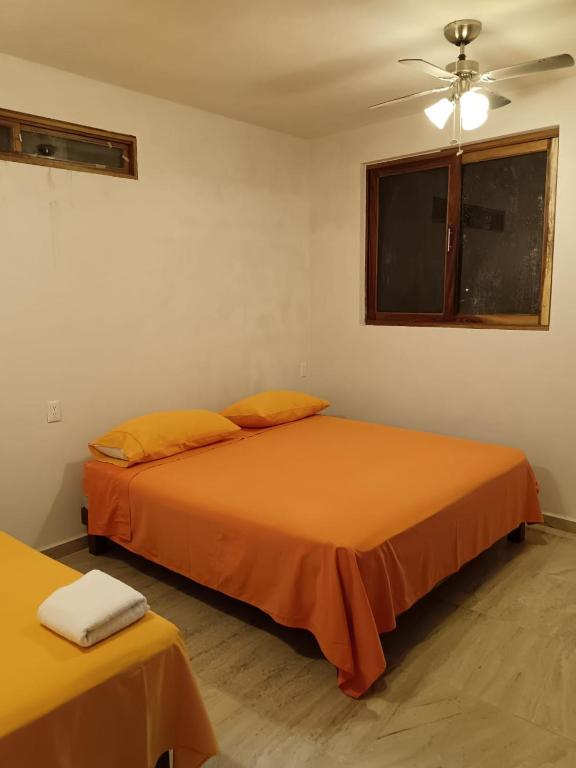 Ένα ή περισσότερα κρεβάτια σε δωμάτιο στο BM Zihua Casa de Huéspedes