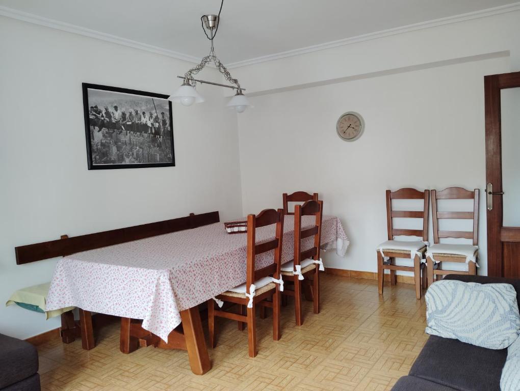 a dining room with a table and chairs at La Fuente de la Covatilla in La Hoya