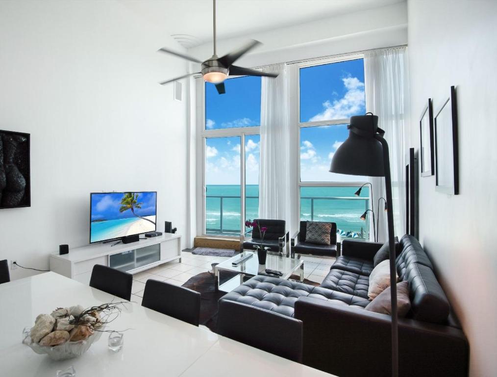 a living room with a couch and a table at Luxury - Ocean front - 3 Bedroom 2 Bathroom - Penthouse in Miami Beach