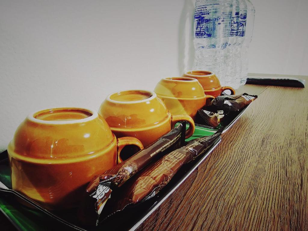 a tray with four cups on a table at Moon's House Hatyai มูนเฮ้าส์ หาดใหญ่ in Hat Yai