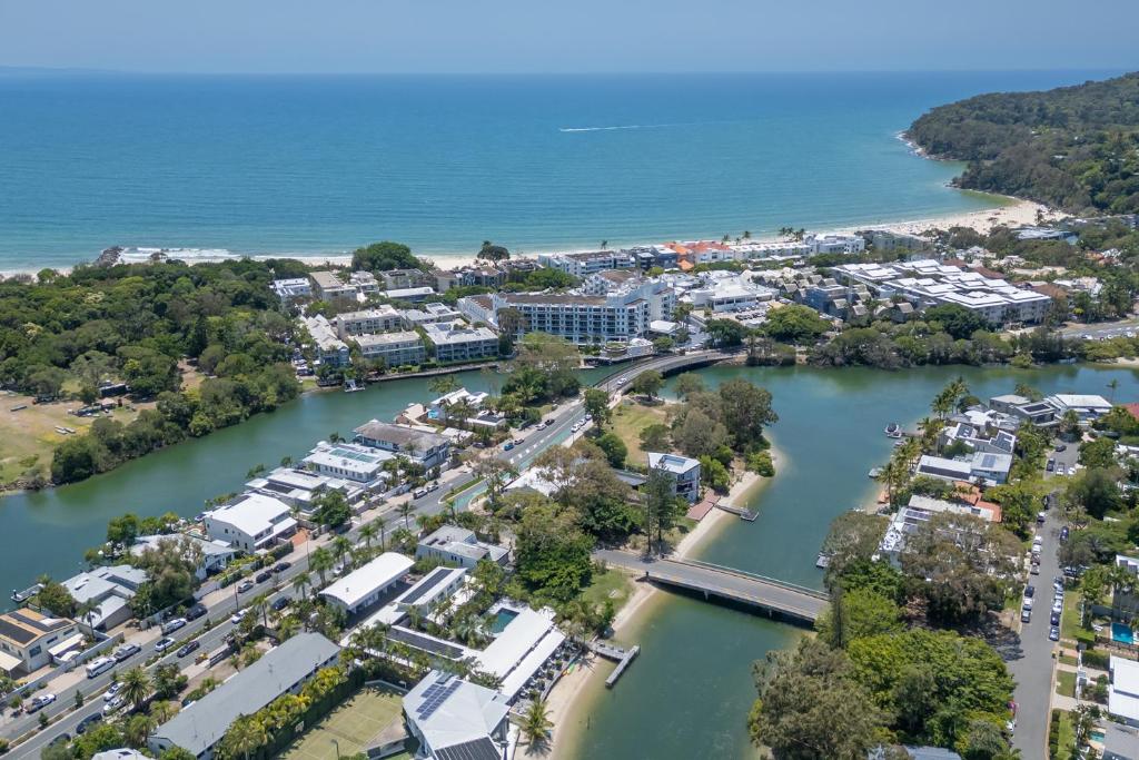 an aerial view of a town next to a body of water at Caribbean Noosa in Noosa Heads